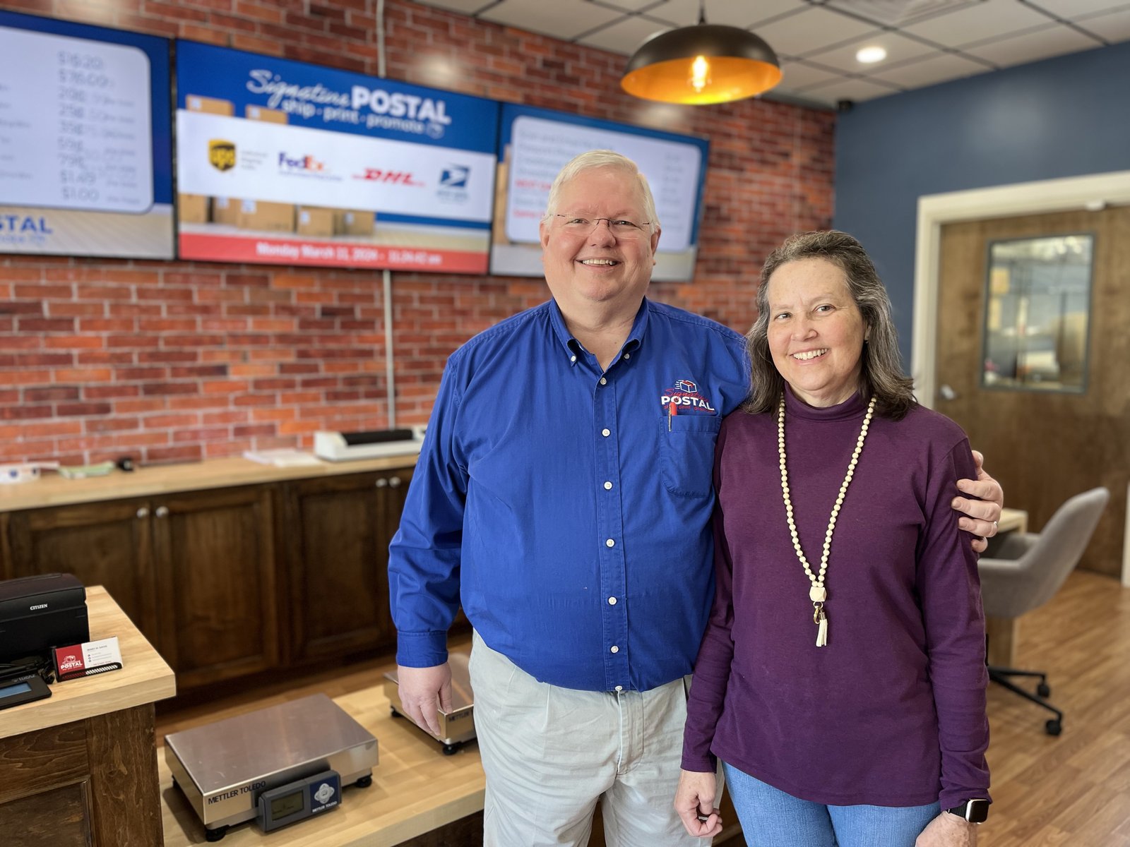 The Davis family behind the counter at Signature Postal in downtown Fuquay-Varina